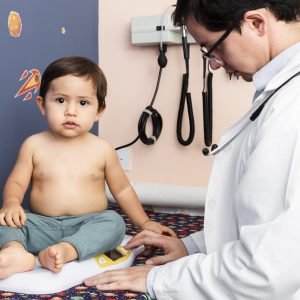 close-up-doctor-weighing-baby-boy